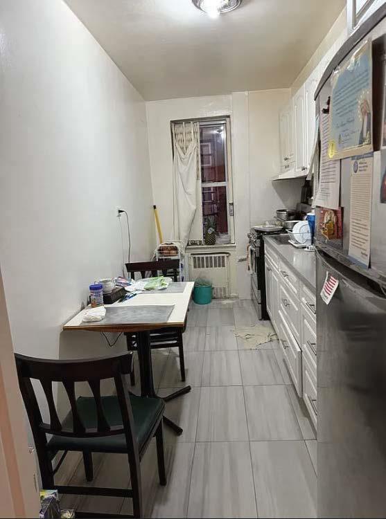 dining room featuring light tile patterned floors and radiator