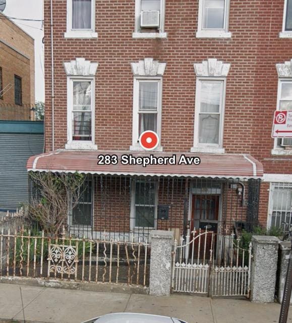 view of building exterior with a fenced front yard