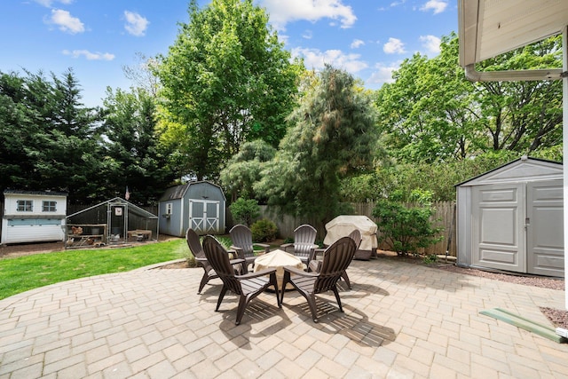 142 Rte 25a, Shoreham, NY 11786 - view of patio / terrace featuring a storage shed, an outbuilding, a fenced backyard, and view of wooded area