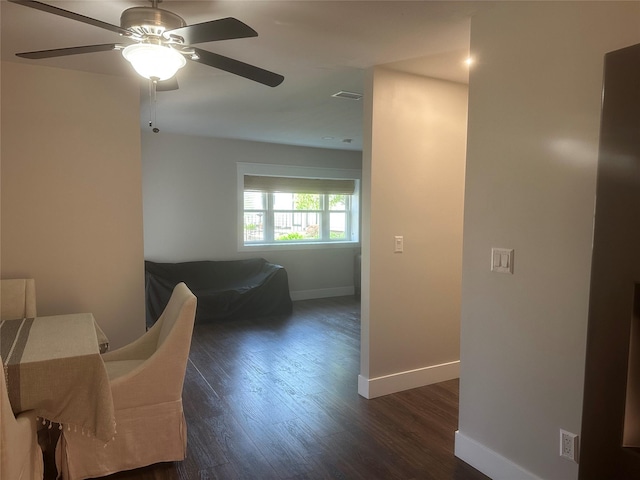 bedroom with baseboards, dark wood finished floors, visible vents, and a ceiling fan