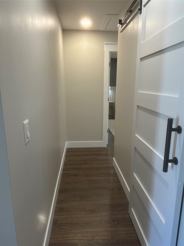 hall with baseboards and dark wood-type flooring
