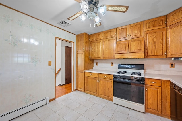 kitchen featuring a baseboard heating unit, visible vents, dishwasher, gas range, and light countertops