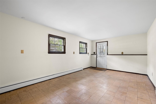 empty room with baseboards and a baseboard heating unit