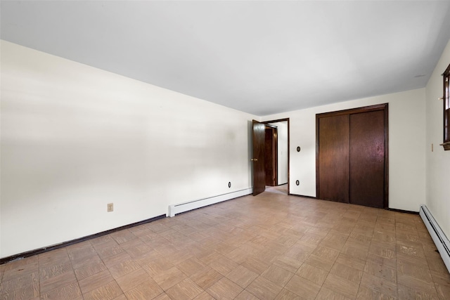 unfurnished bedroom with a baseboard radiator, baseboards, a closet, and baseboard heating