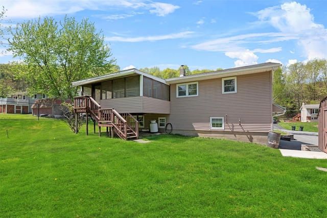 rear view of property featuring a sunroom, a yard, a chimney, and stairs