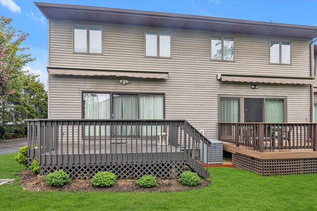 back of house with a wooden deck and a yard