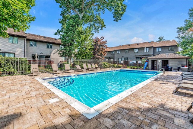 community pool featuring a patio area and fence