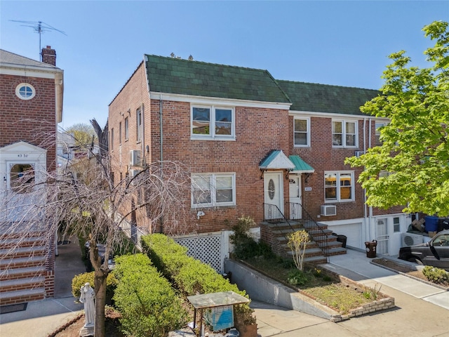 43-28 196th St, Flushing, NY 11358 - view of property with brick siding, an attached garage, and a shingled roof