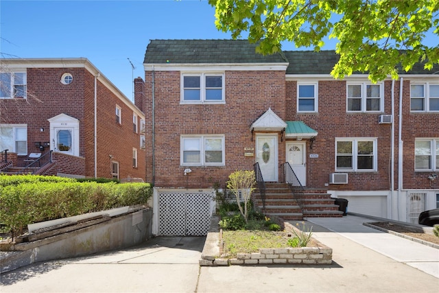 43-28 196th St, Flushing, NY 11358 - view of property featuring a garage, concrete driveway, and brick siding