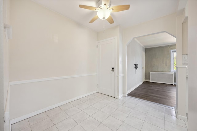 43-28 196th St, Flushing, NY 11358 - spare room featuring baseboards, arched walkways, ceiling fan, and light tile patterned floors