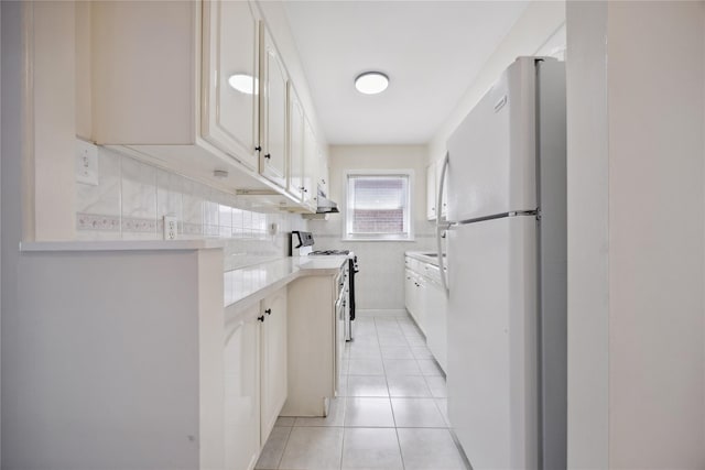 43-28 196th St, Flushing, NY 11358 - kitchen featuring freestanding refrigerator, gas range, light countertops, white cabinets, and light tile patterned floors