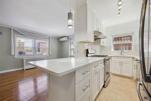 43-28 196th St, Flushing, NY 11358 - kitchen featuring appliances with stainless steel finishes, a sink, light countertops, radiator, and under cabinet range hood