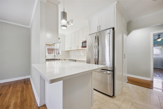 43-28 196th St, Flushing, NY 11358 - kitchen featuring white cabinets, light countertops, freestanding refrigerator, baseboards, and backsplash