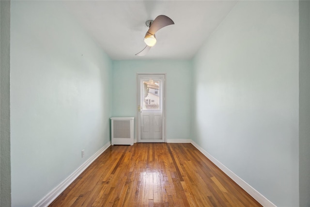 43-28 196th St, Flushing, NY 11358 - doorway to outside with radiator, baseboards, and hardwood / wood-style flooring