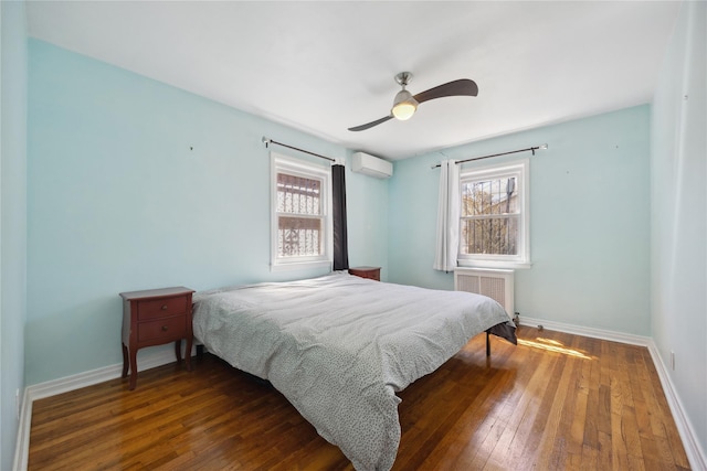 43-28 196th St, Flushing, NY 11358 - bedroom featuring baseboards, multiple windows, wood-type flooring, and a wall mounted AC