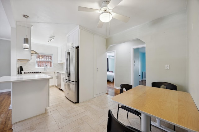 43-28 196th St, Flushing, NY 11358 - kitchen featuring a ceiling fan, light countertops, a sink, stainless steel appliances, and white cabinetry