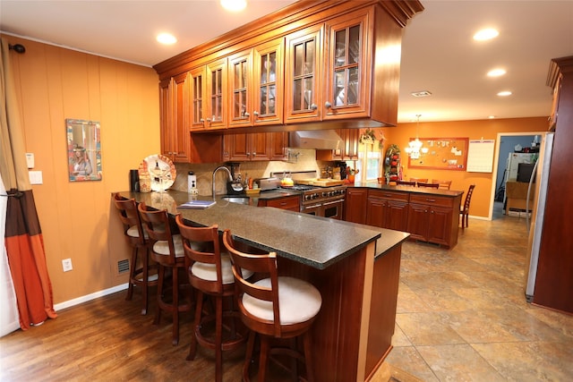 8 Rolling Way, New City, NY 10956 - kitchen with a peninsula, a sink, dark countertops, double oven range, and baseboards