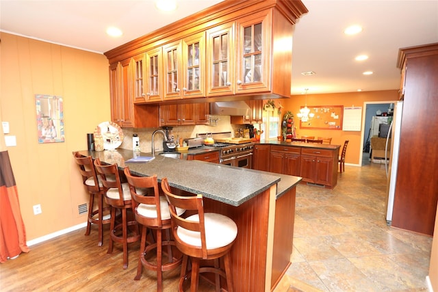 8 Rolling Way, New City, NY 10956 - kitchen featuring range with two ovens, baseboards, a peninsula, and recessed lighting
