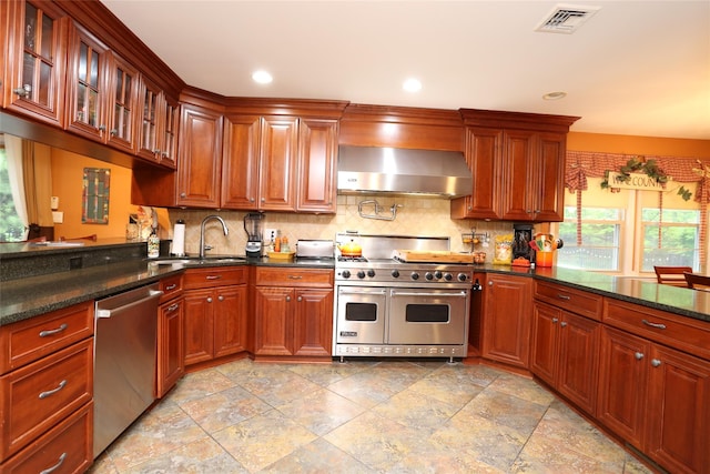 8 Rolling Way, New City, NY 10956 - kitchen featuring a sink, wall chimney exhaust hood, stainless steel appliances, visible vents, and backsplash