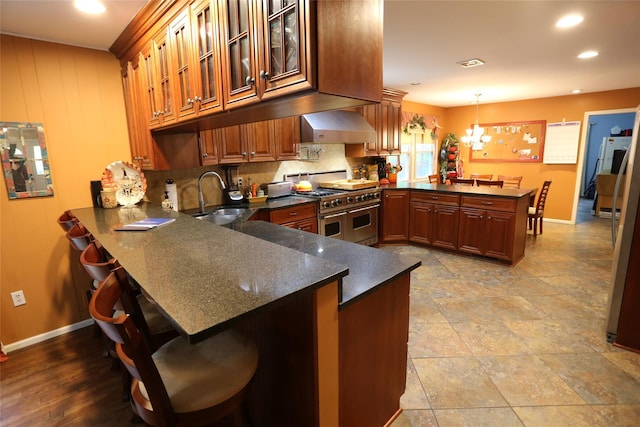 8 Rolling Way, New City, NY 10956 - kitchen with a peninsula, a sink, wall chimney exhaust hood, range with two ovens, and baseboards
