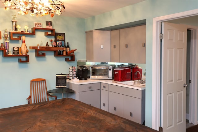 8 Rolling Way, New City, NY 10956 - kitchen featuring open shelves, a toaster, an inviting chandelier, light countertops, and gray cabinetry