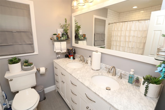 8 Rolling Way, New City, NY 10956 - bathroom featuring double vanity, toilet, baseboards, and a sink