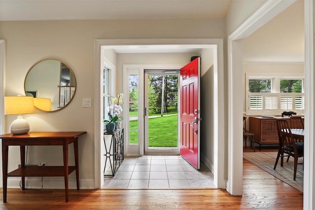 foyer entrance featuring light wood-style flooring and baseboards