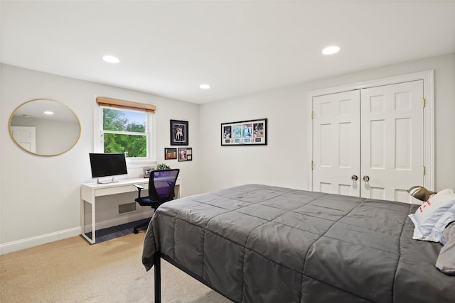 bedroom featuring light colored carpet, recessed lighting, baseboards, and a closet