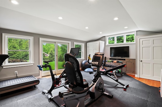 workout room with vaulted ceiling, light wood-type flooring, recessed lighting, and baseboards