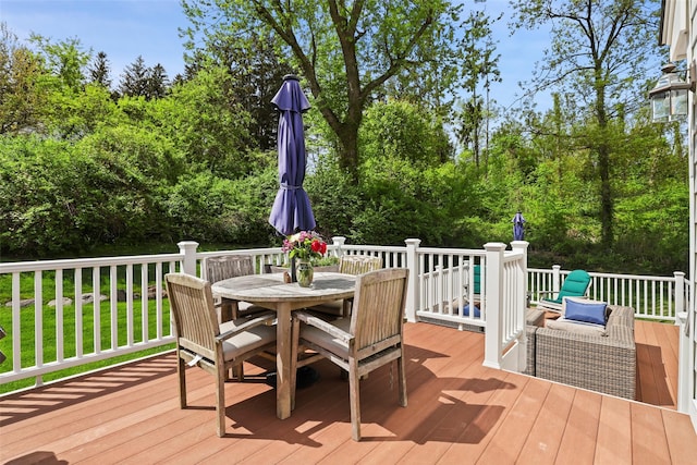 wooden terrace with outdoor dining space