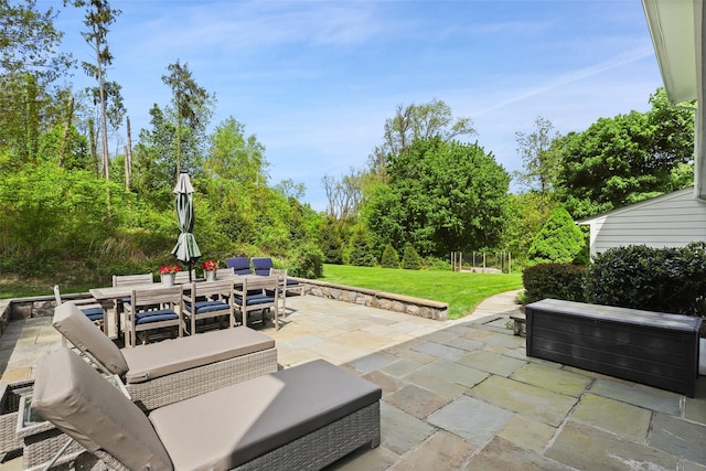 view of patio with outdoor dining space and a hot tub