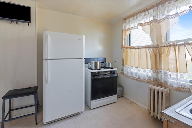 kitchen with radiator, white appliances, and light tile patterned flooring