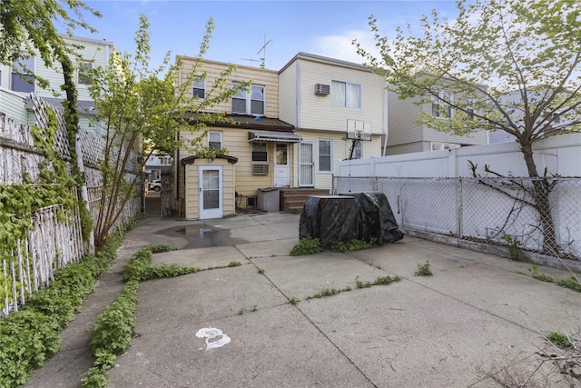 back of property featuring a patio area and fence