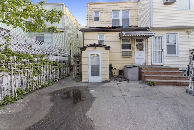 rear view of property with a patio and fence