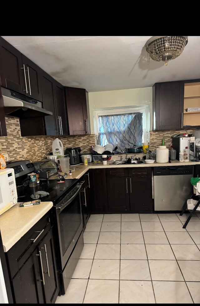 87-17 95th Ave, Ozone Park, NY 11416 - kitchen with black range with electric cooktop, dishwasher, under cabinet range hood, and light tile patterned floors