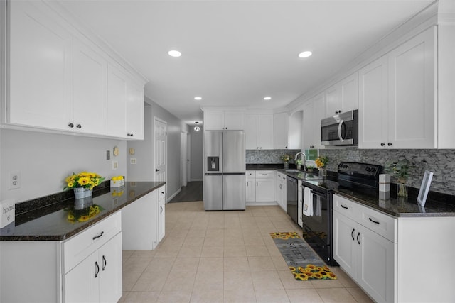 kitchen featuring decorative backsplash, light tile patterned flooring, white cabinets, a sink, and black appliances