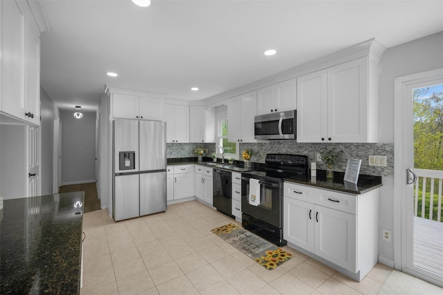 kitchen featuring white cabinetry, black appliances, and tasteful backsplash