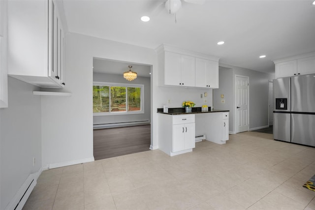 kitchen with baseboards, baseboard heating, and stainless steel refrigerator with ice dispenser