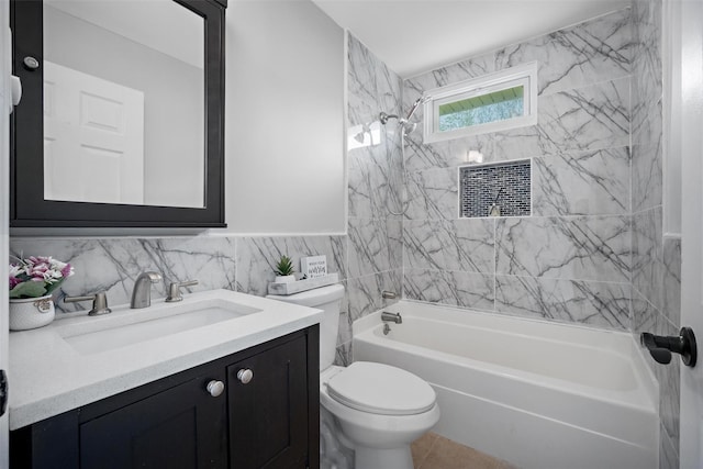 bathroom featuring washtub / shower combination, vanity, toilet, and tile walls