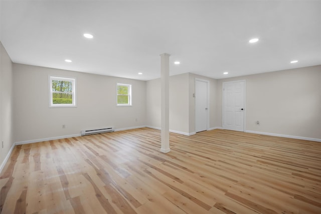 basement with recessed lighting, baseboards, a baseboard radiator, and light wood finished floors