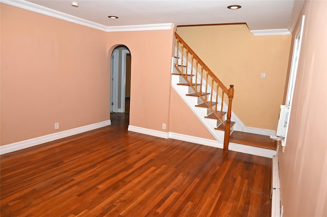 interior space with baseboards, ornamental molding, and dark wood-style flooring