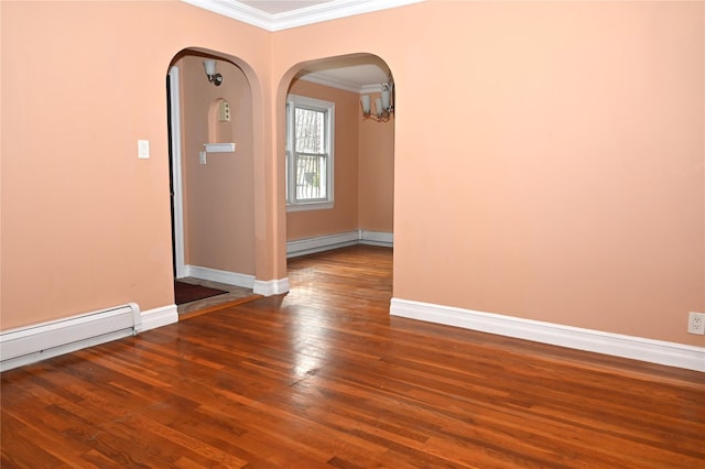 empty room featuring crown molding, wood-type flooring, baseboards, a baseboard heating unit, and arched walkways