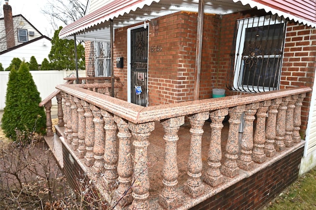 view of home's exterior with brick siding and fence