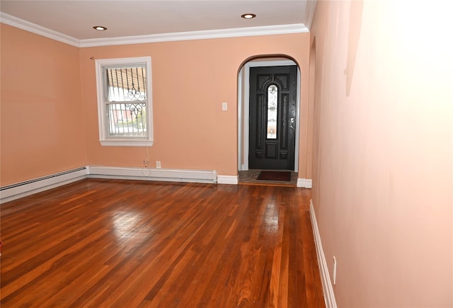 foyer with arched walkways, baseboards, ornamental molding, and wood finished floors