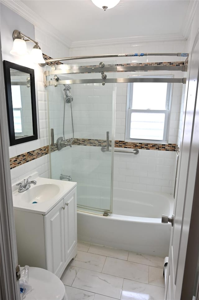 full bath featuring vanity, ornamental molding, marble finish floor, and bath / shower combo with glass door
