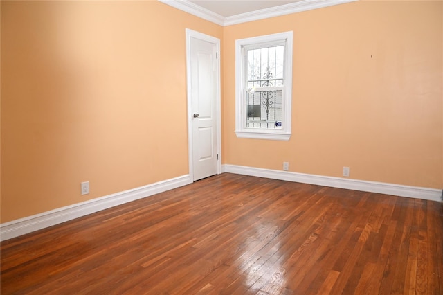 unfurnished room featuring baseboards, dark wood-style floors, and ornamental molding