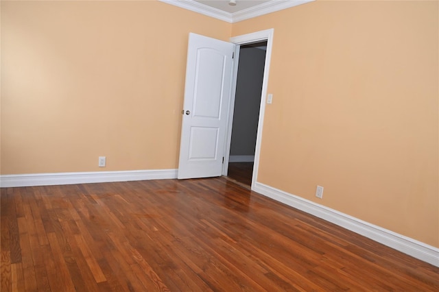 unfurnished room with crown molding, baseboards, and dark wood-style floors
