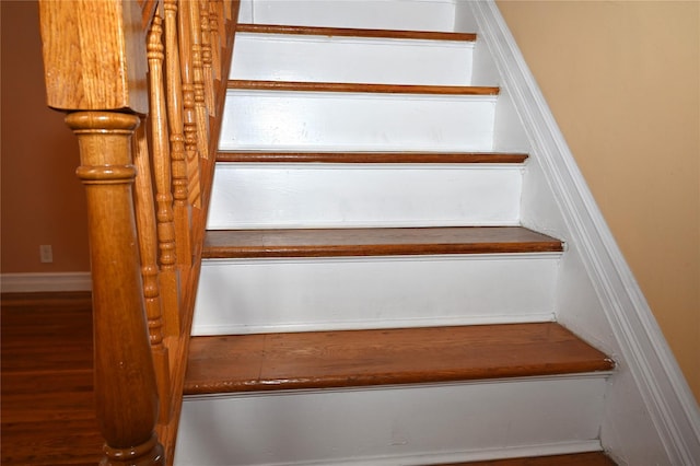 stairway featuring wood finished floors
