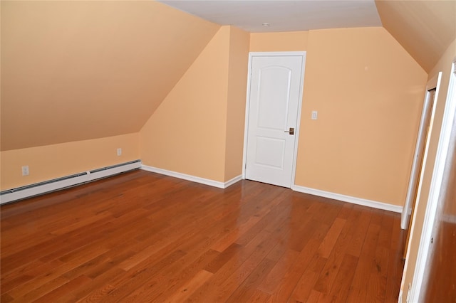 bonus room featuring baseboards, vaulted ceiling, a baseboard heating unit, and wood finished floors