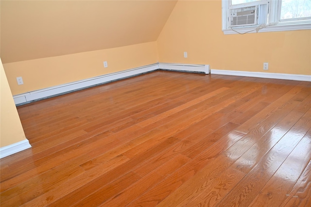 bonus room featuring baseboards, vaulted ceiling, hardwood / wood-style flooring, and baseboard heating
